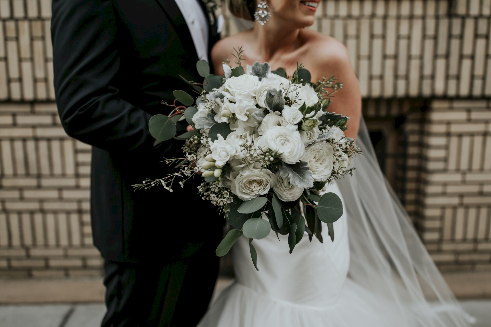 man and woman walking in downtown portland with wedding attire